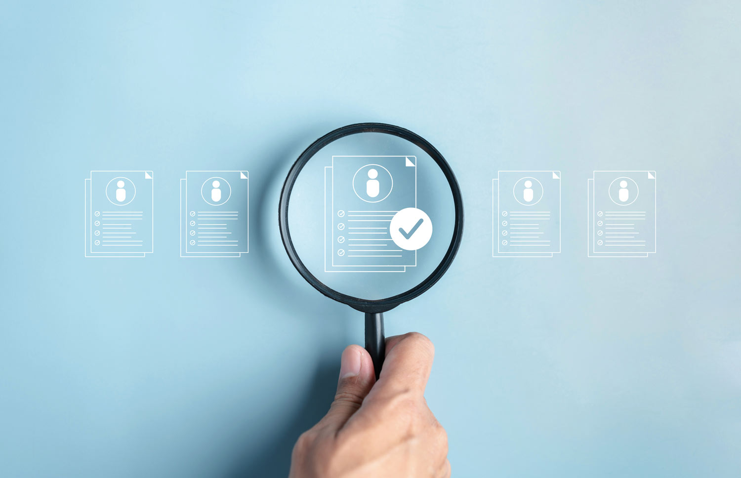 talent-acquisition Magnifying glass hovering over images of line art resumes